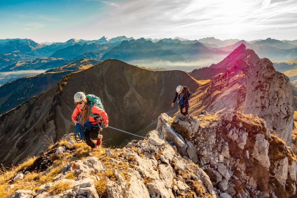 two men climbing a mountain