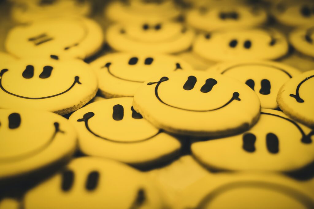 round cookies iced with smiley faces